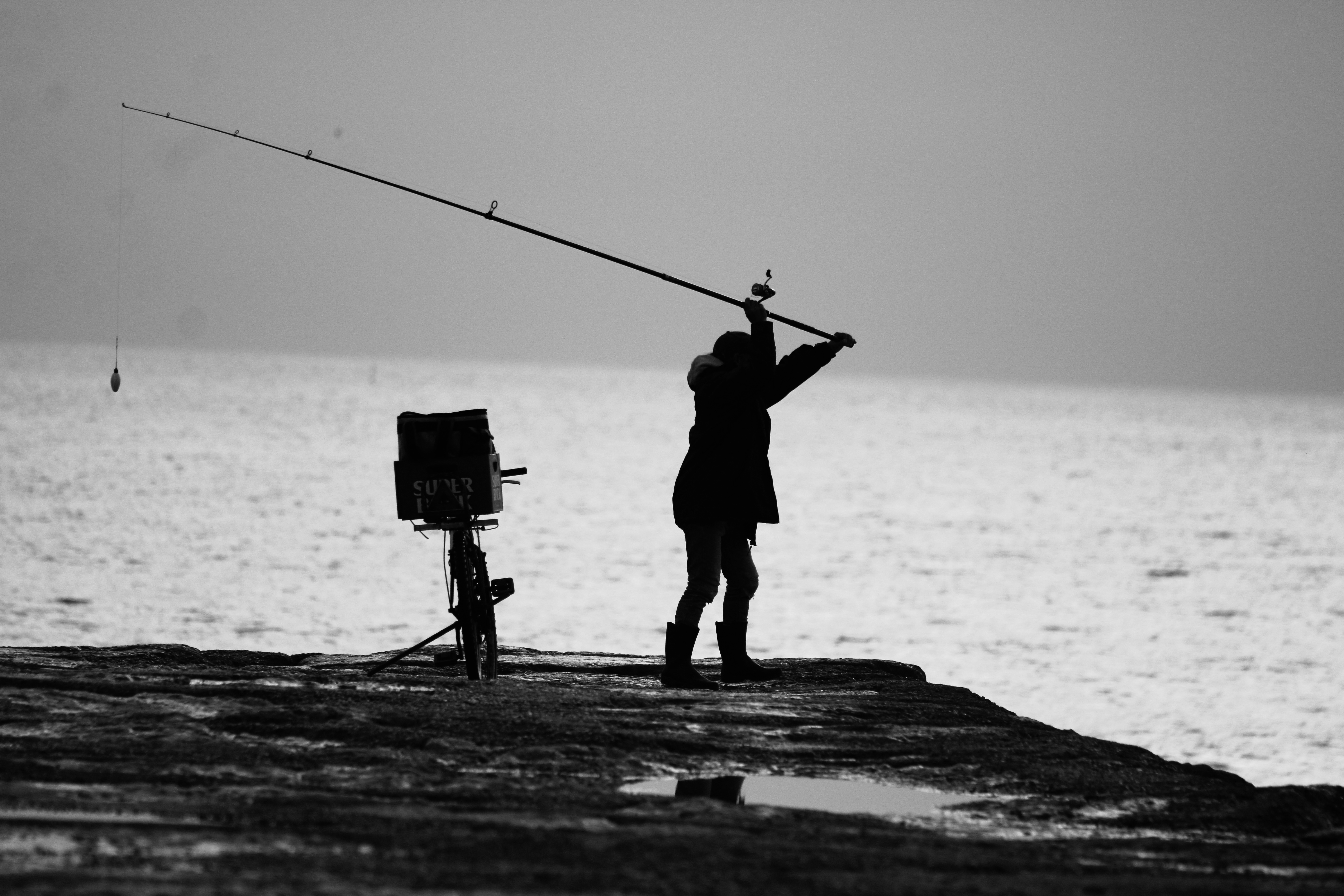 Fisherman casting B&W